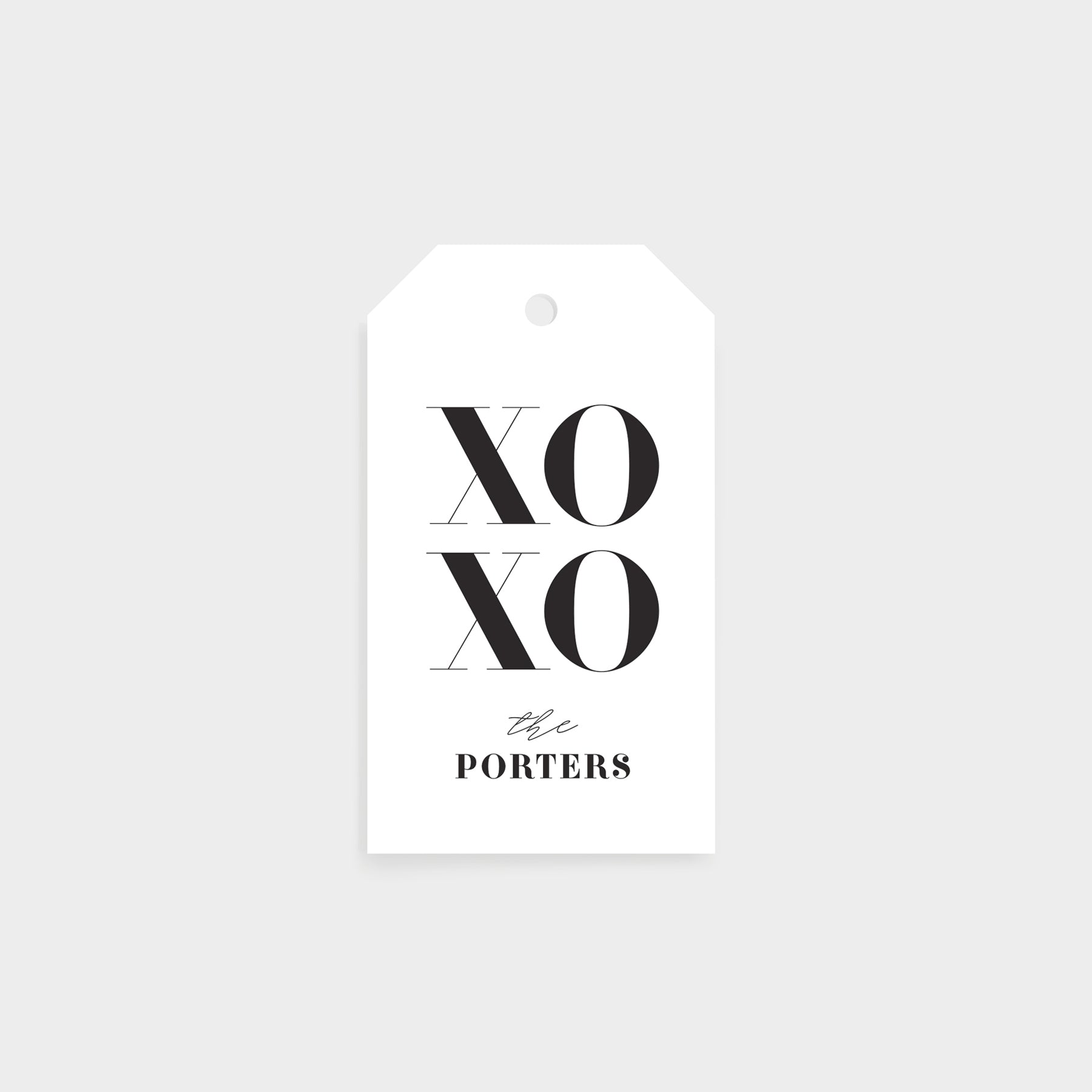 Personalized gift tag featuring bold black XOXO design with custom family name in elegant script below.
