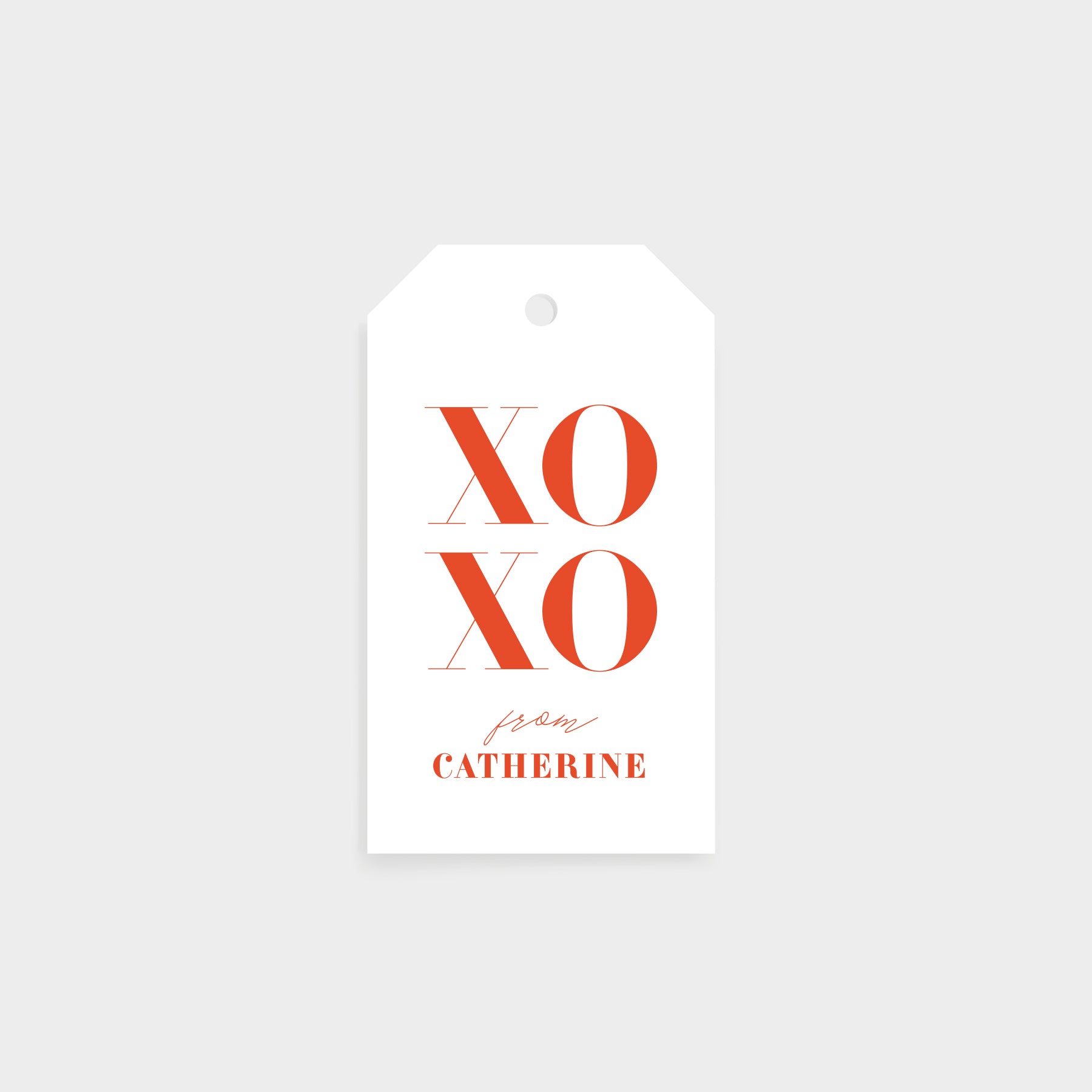Personalized gift tag featuring bold coral XOXO design with custom name in elegant script below.