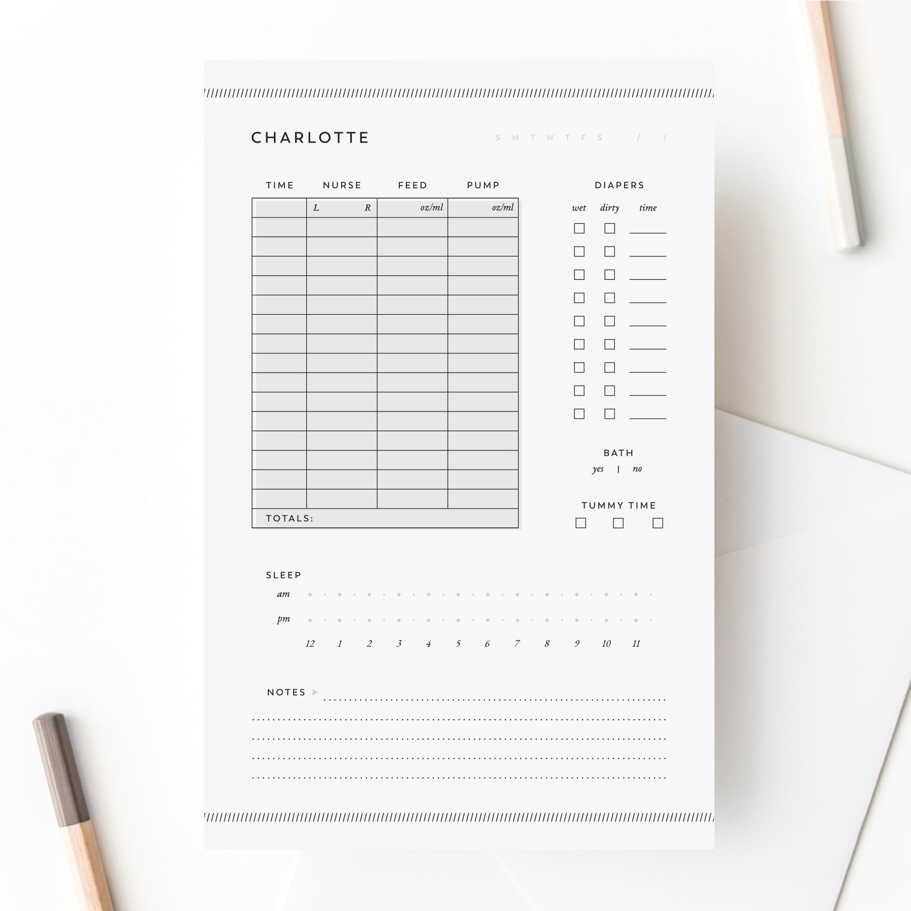 Personalized baby care log notepad with sections for feeding, sleep, diapers, and notes shown on white desk with pencils.