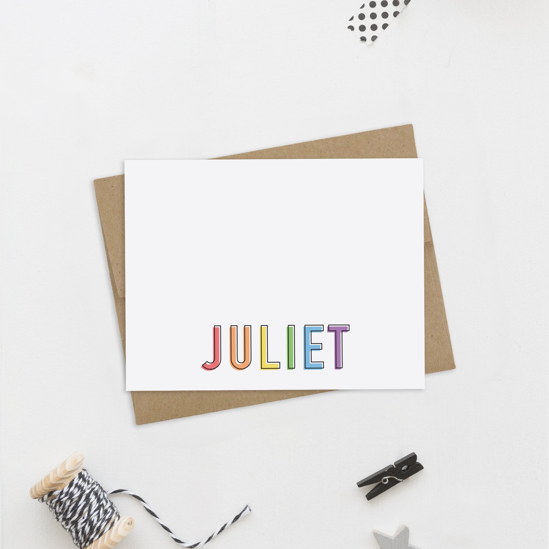 Color block personalized stationery with rainbow lettering and kraft envelope on white background.