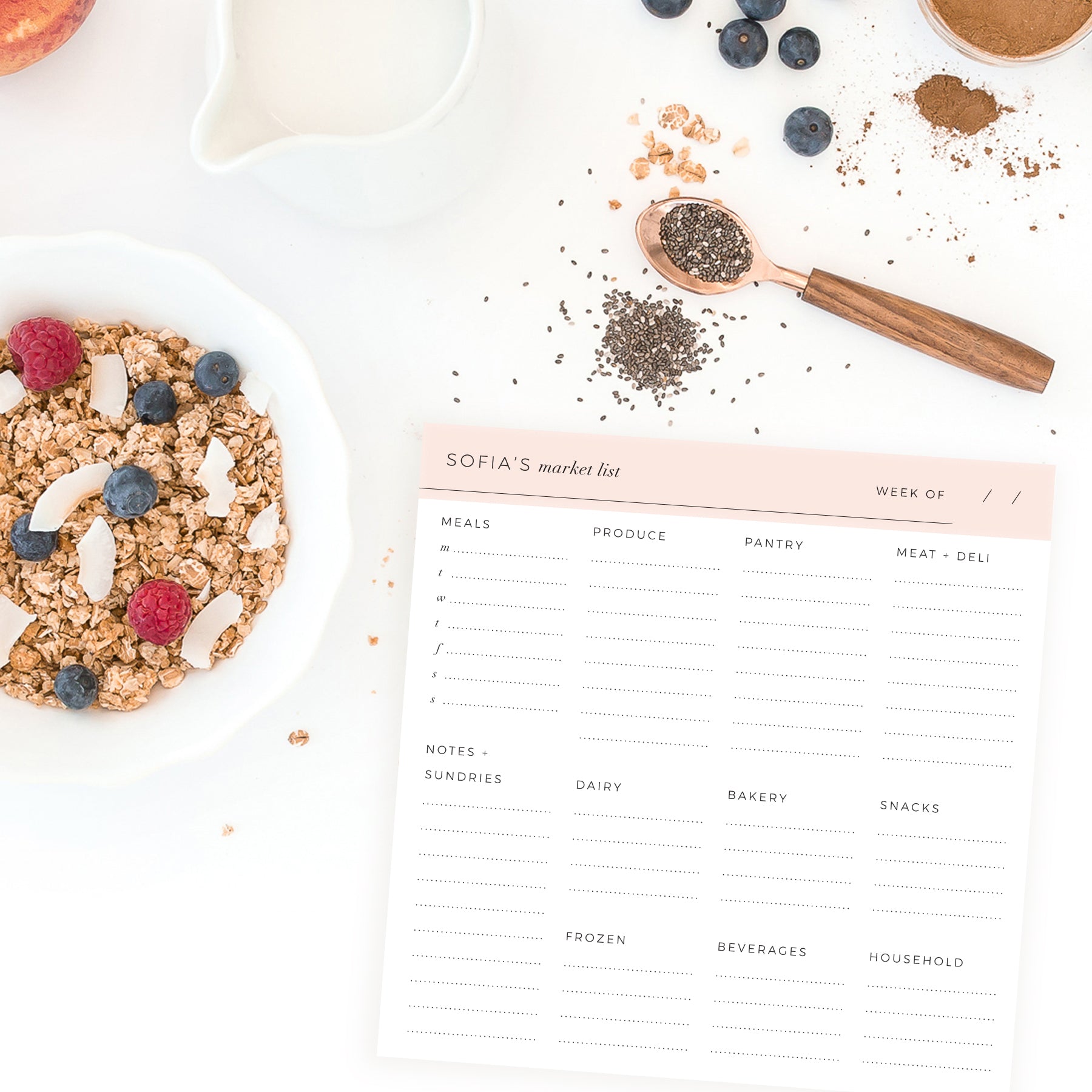 Styled image of personalized Weekly Market List Notepad in blush pink with breakfast ingredients, granola, and berries on a white kitchen counter